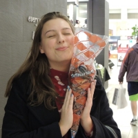 Tiffany holding a polybag of cinnamon roasted nuts 